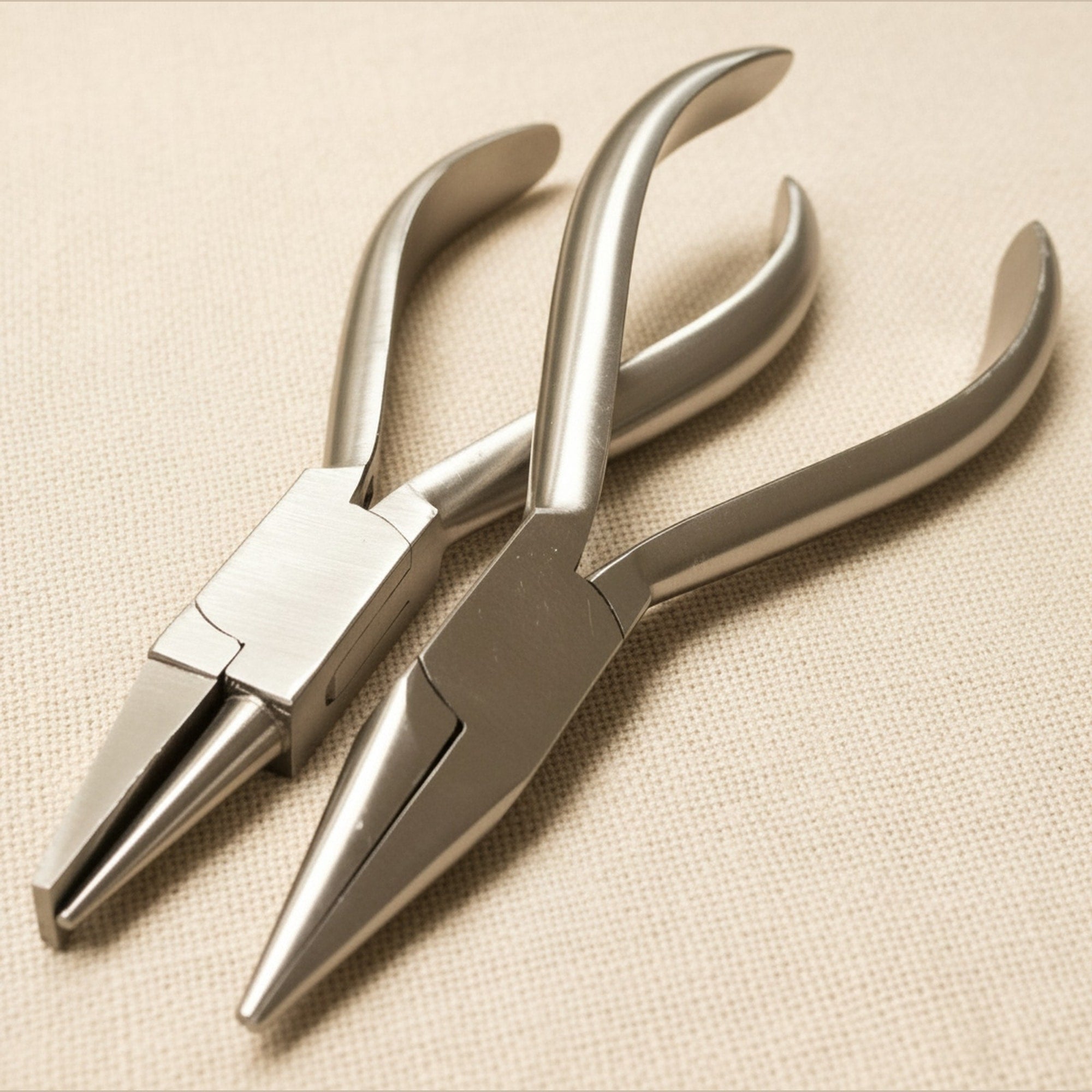 A two-piece set of stainless steel orthodontic pliers, one with round/flat jaws and one with chain nose jaws, shown on a white background.