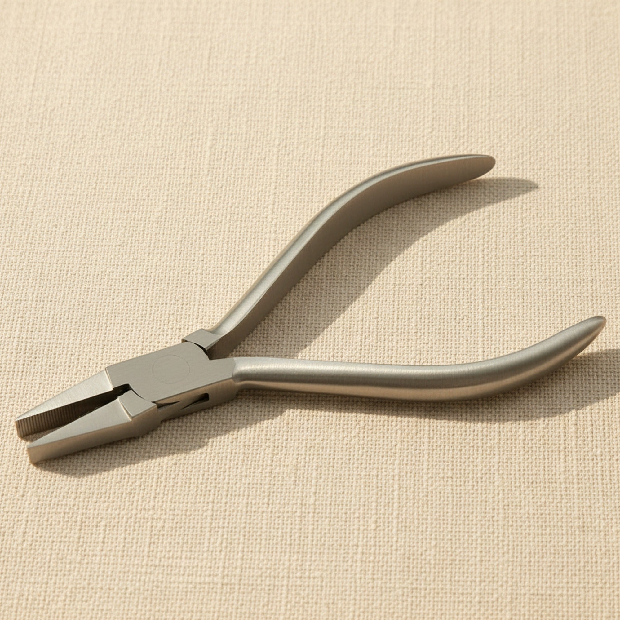 A pair of 14 cm stainless steel flat nose utility pliers with a box joint, shown on a white background.