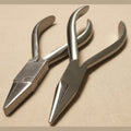 Set of two 14 cm stainless steel orthodontic pliers: one chain nose and one flat nose, shown side-by-side on a white background.