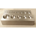 Flat steel dapping block showing 14 half-sphere depressions on a white background.