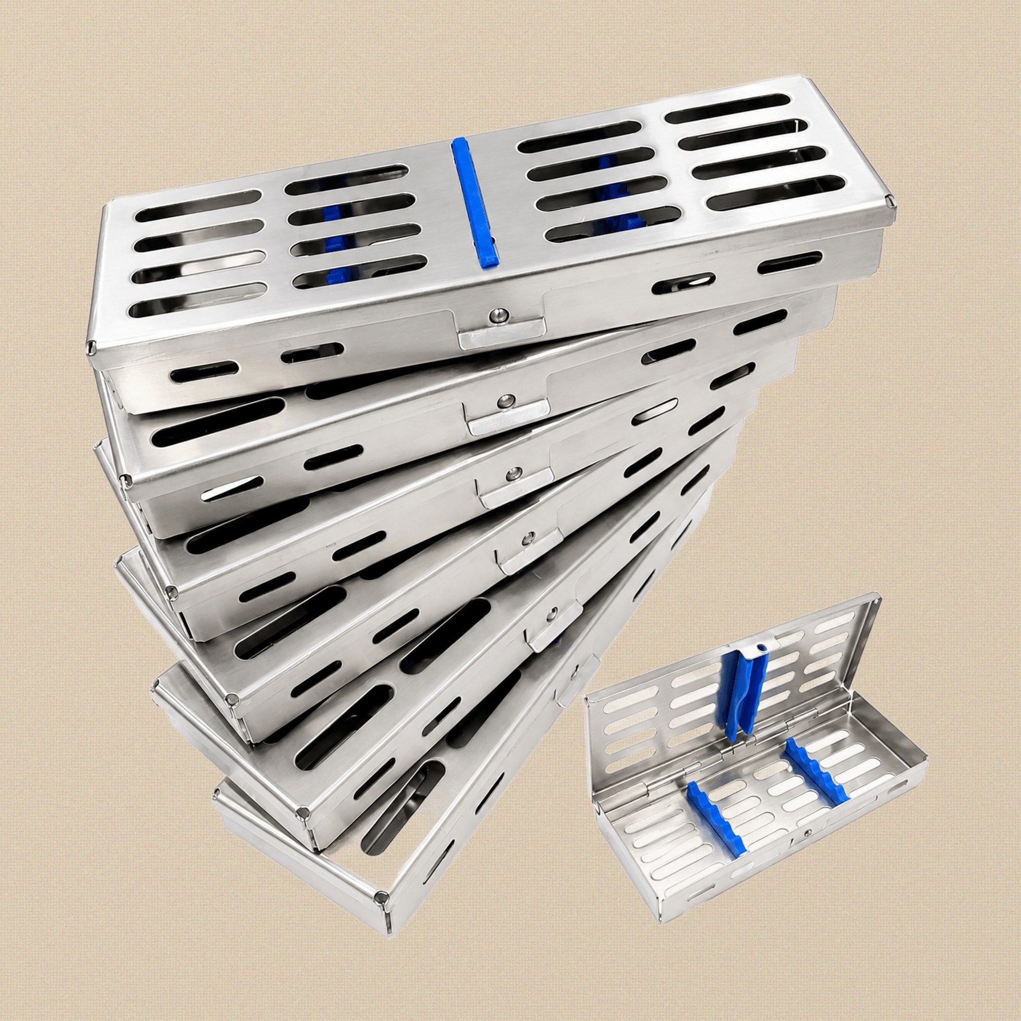 Set of six stainless steel dental instrument sterilisation cassettes, stacked and fanned out on a white background.