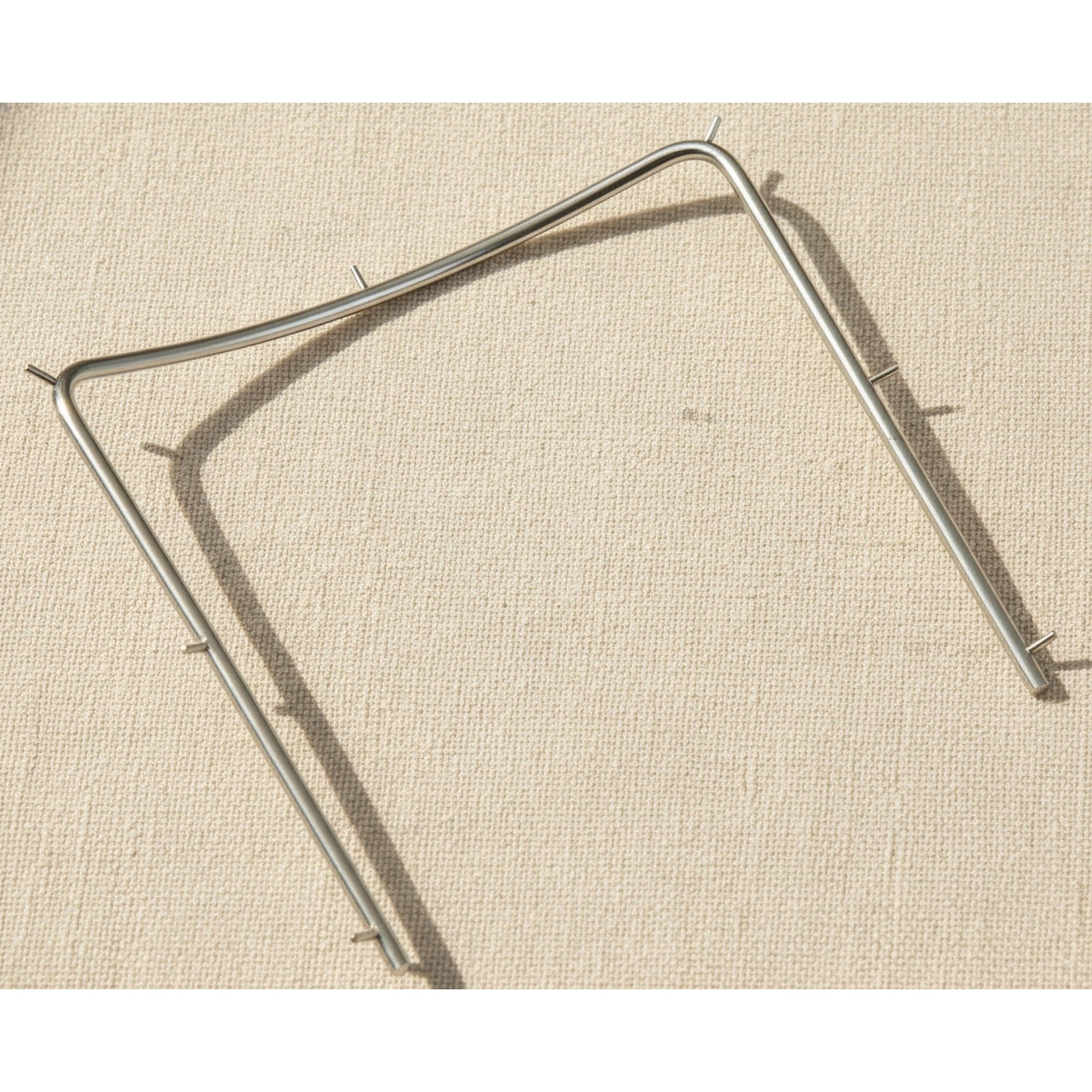 Close-up of the polished stainless steel finish on the rubber dam frame.