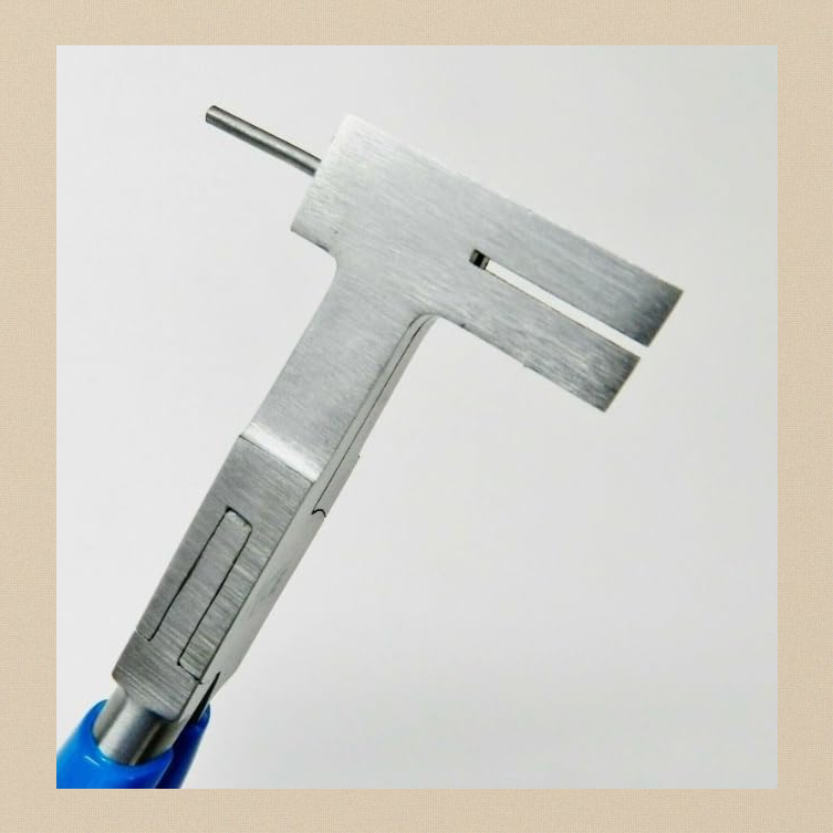 Close-up of the brushed stainless steel jaw with the saw-guide slit and pin