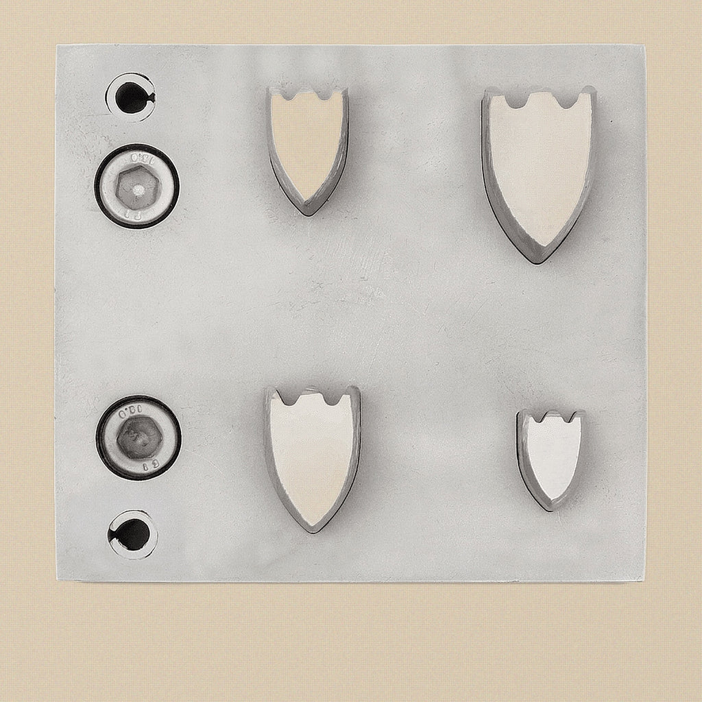 Shield-shape disc cutter set with four punches and steel die block.
