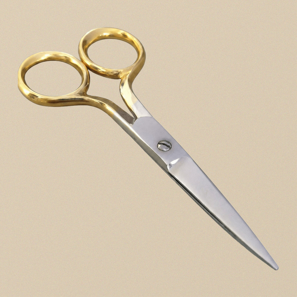 A pair of 90 mm fine-point cuticle scissors with gold-plated bow handles, shown closed against a white background.