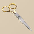 A pair of 90 mm fine-point cuticle scissors with gold-plated bow handles, shown closed against a white background.