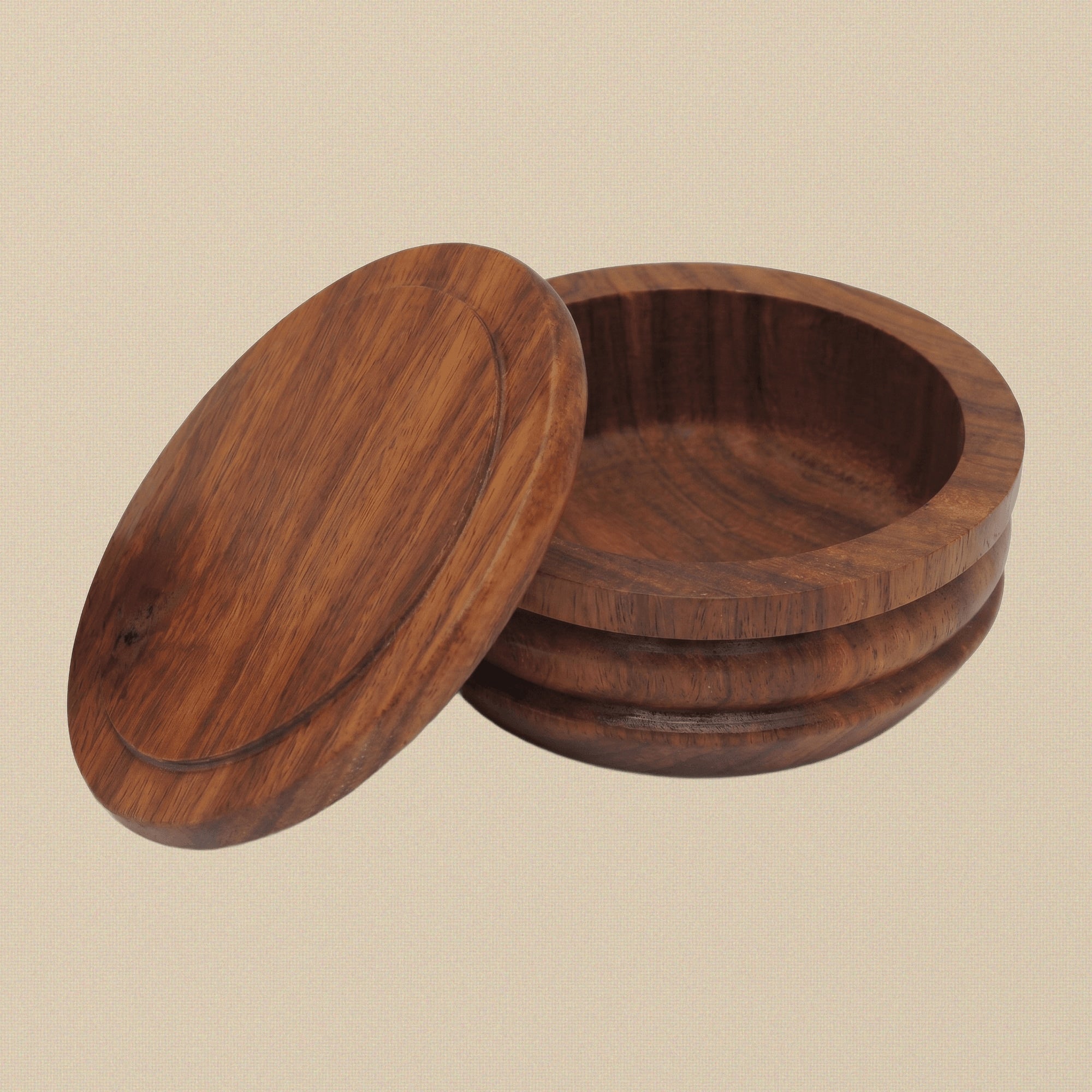 Solid wood shaving soap bowl with its lid on, shown from a three-quarter angle.