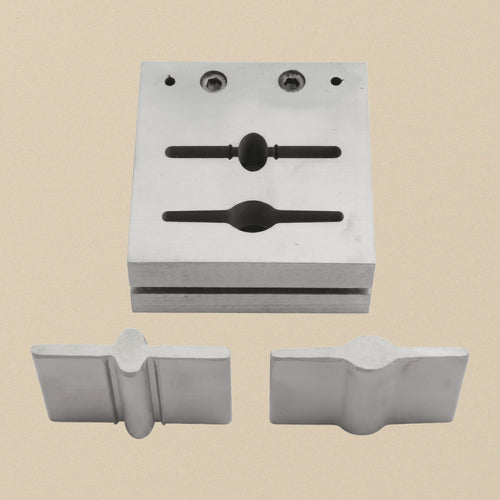 Bar and paddle steel disc cutter set, die block with two slots and the two punches laid out below it