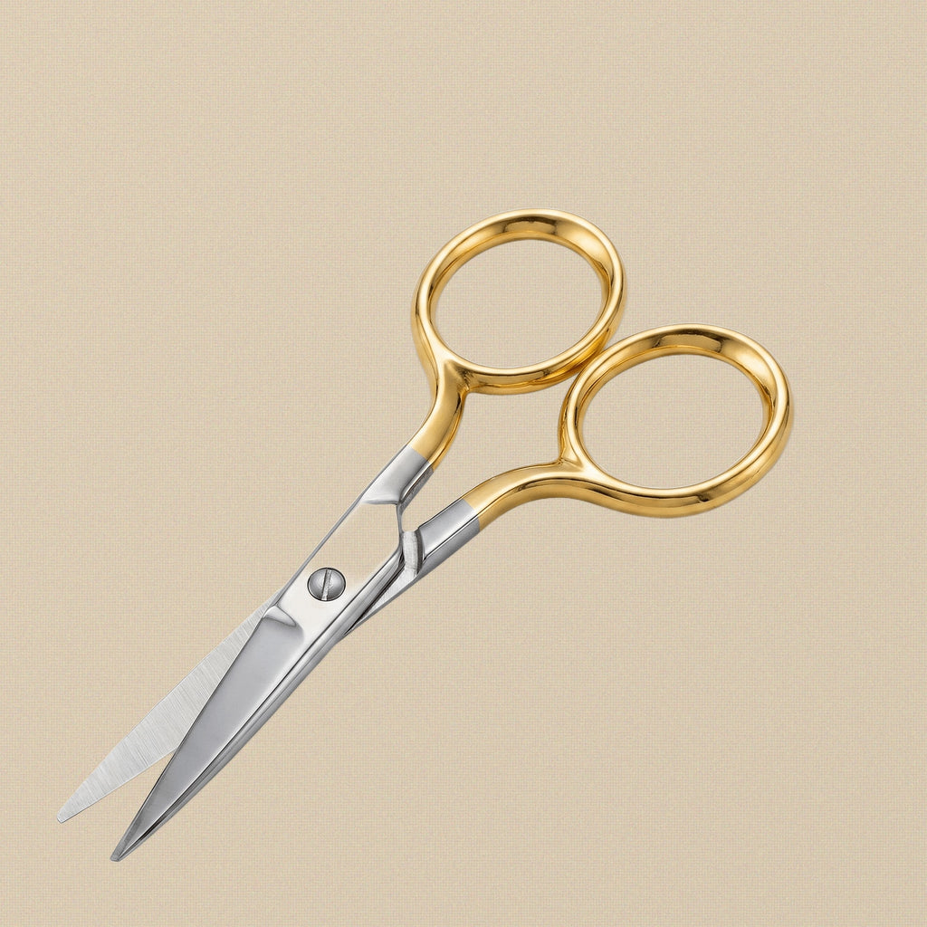 Detail view of the curved stainless steel blades on the 90 mm gold-plated grooming scissors.