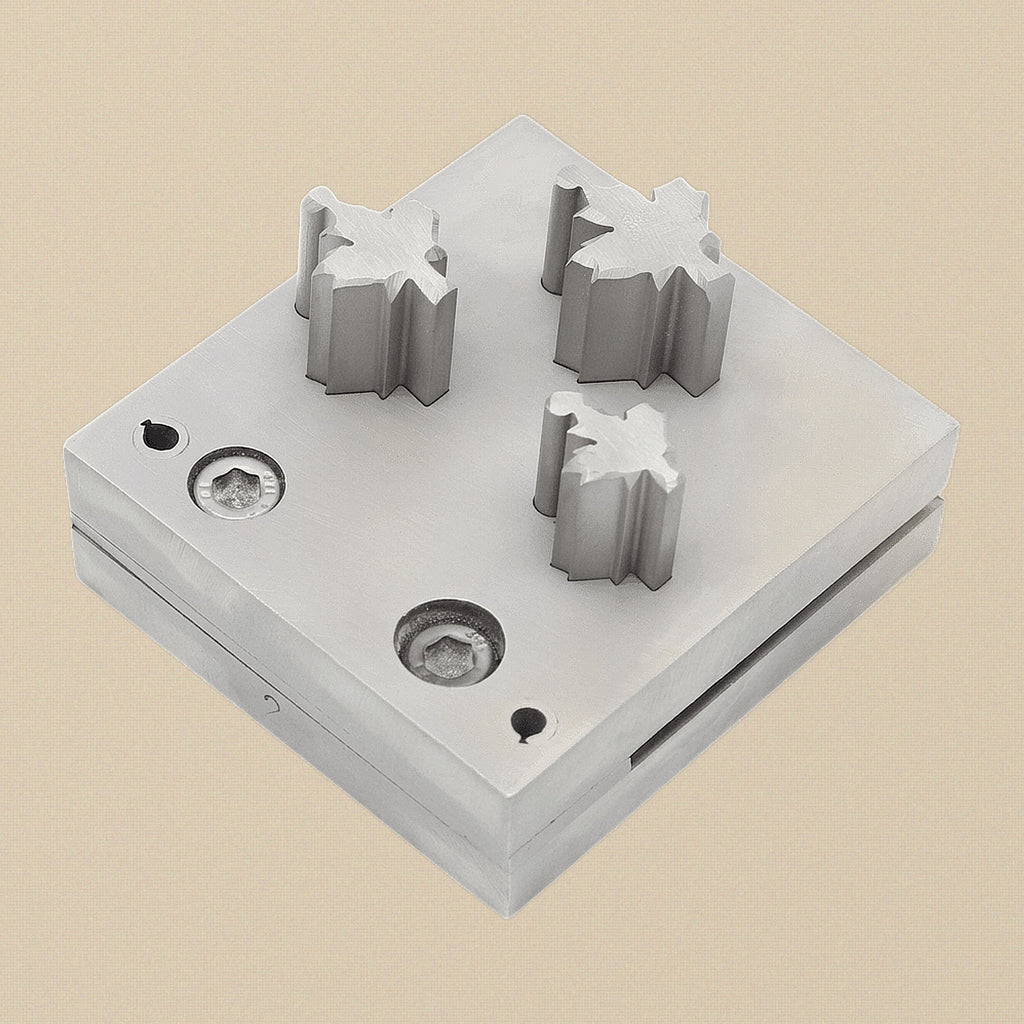 The 64x89mm solid steel die block showing the three maple leaf shaped apertures.