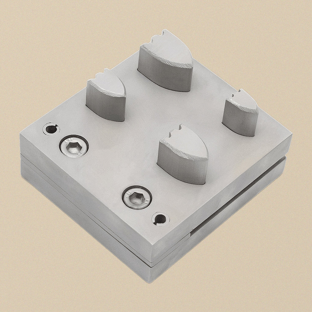 The four hardened steel punches arranged by size, showing cutting and striking ends.