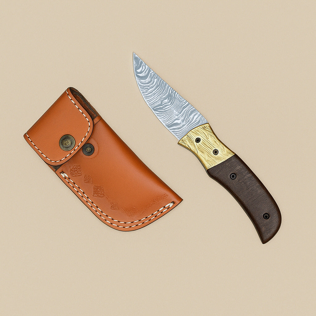 Fire-pattern damascus folding knife open beside its tan leather belt sheath with a press stud
