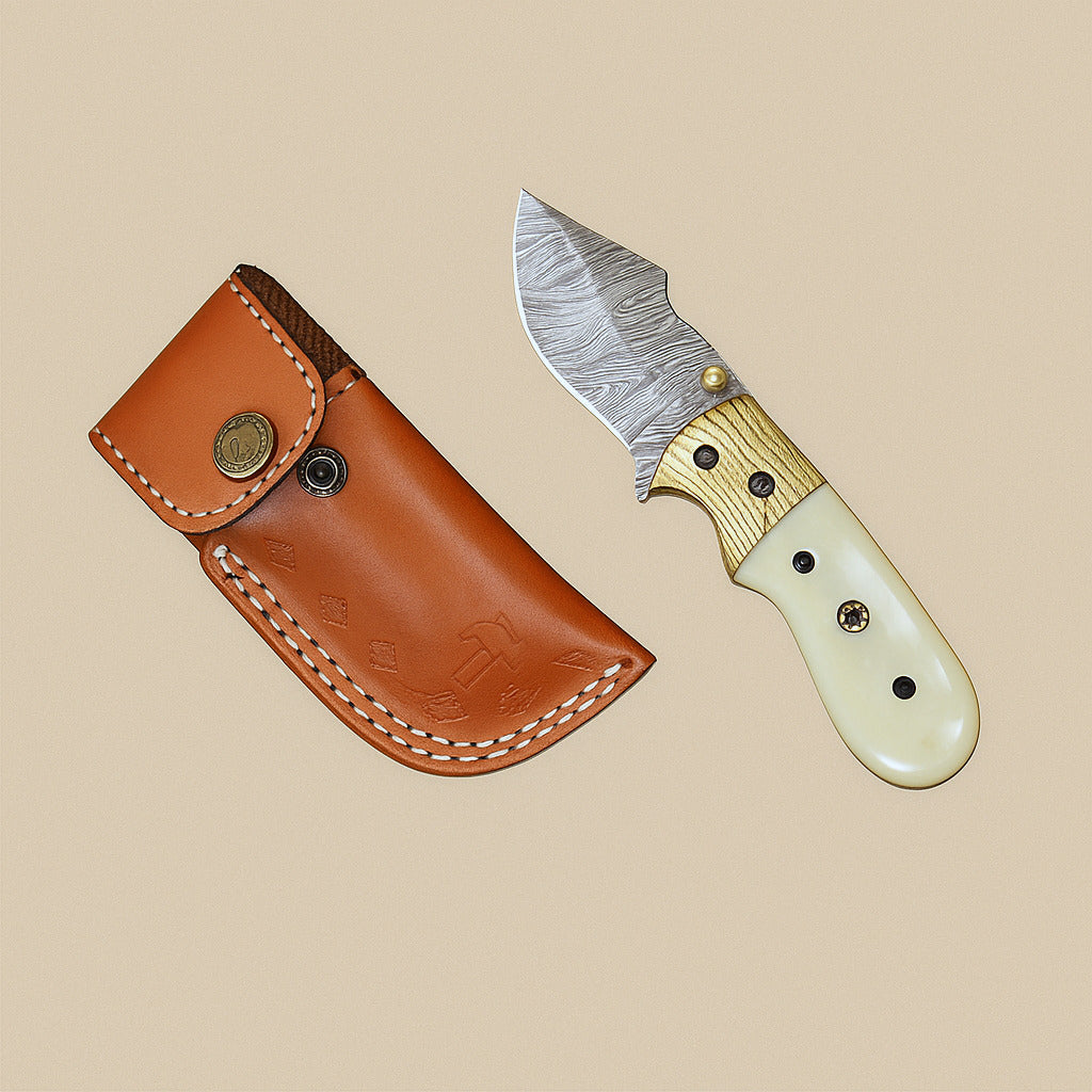Folding pocket knife with bone handle, open, beside its embossed leather sheath