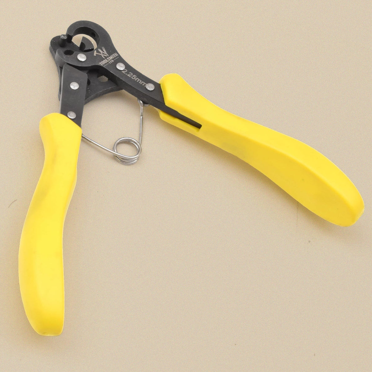 One step looper pliers, 2.25 mm, yellow grips, seen from the other side with the jaws open at top left