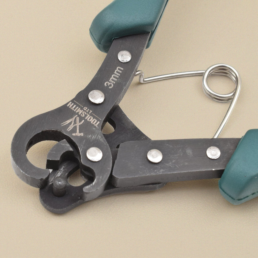 Close-up of the 3 mm looper head with the Toolsmith Ltd logo etched on it, the riveted jaws and loop-forming pin