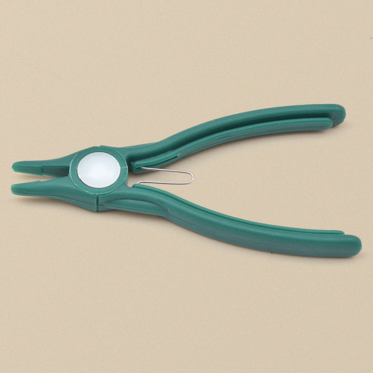 Green plastic flat nose pliers from the side, showing the nylon jaw