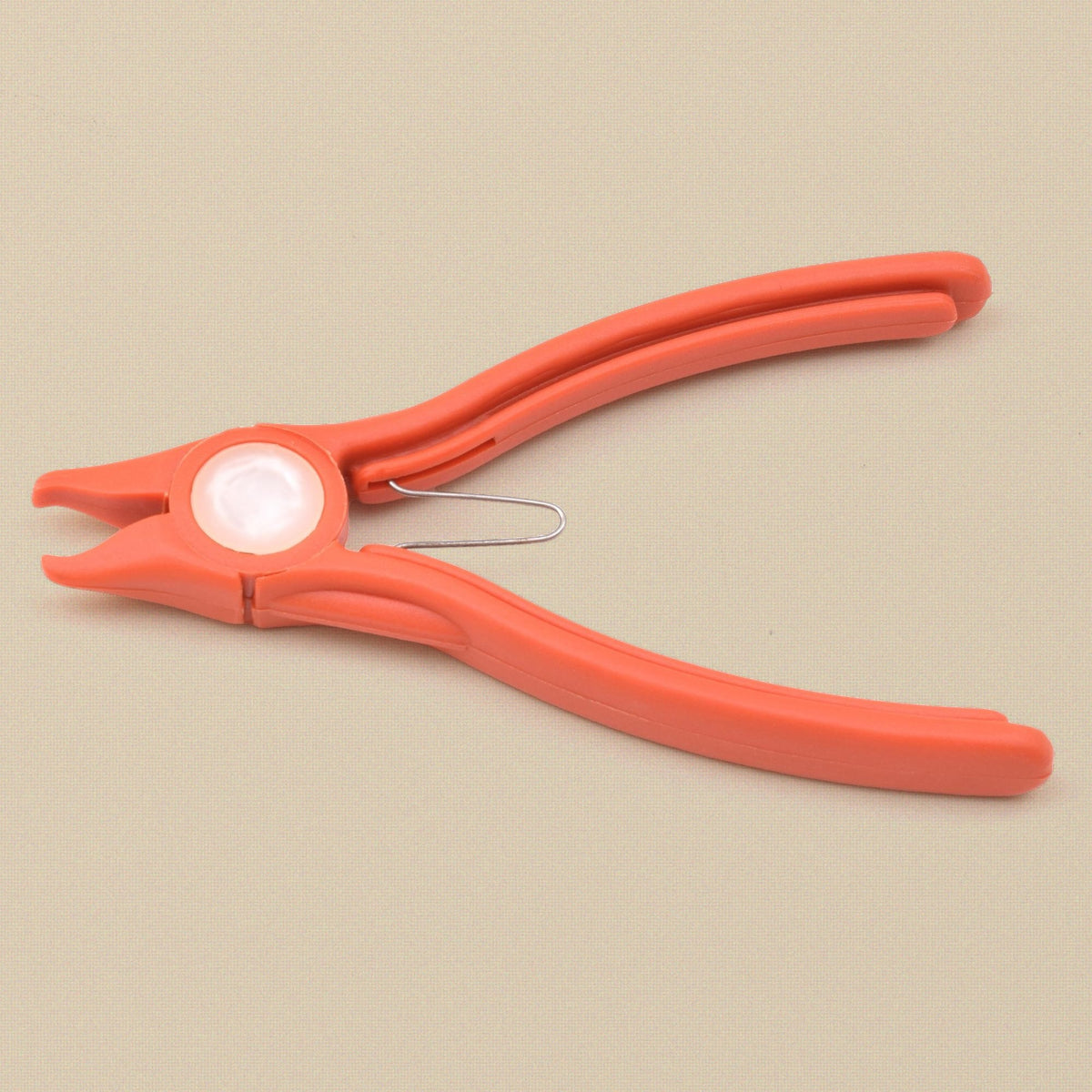 Orange plastic stone setting pliers from the side, showing the nylon jaw