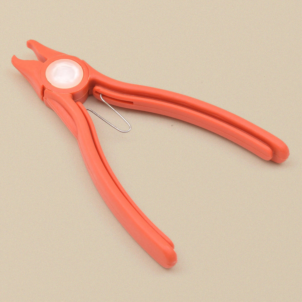 Orange plastic stone setting pliers at an angle