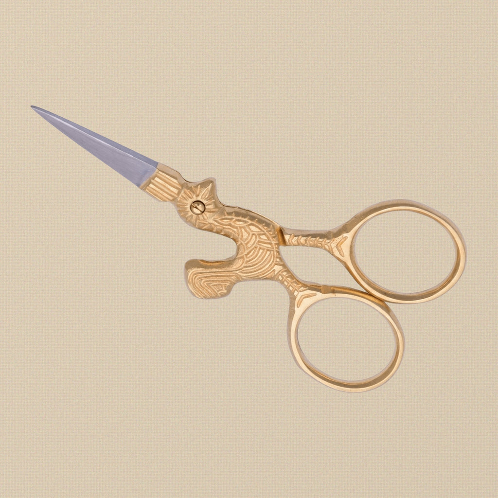 Detail shot of the gold-plated hen-shaped handles on the 3.5-inch embroidery scissors.
