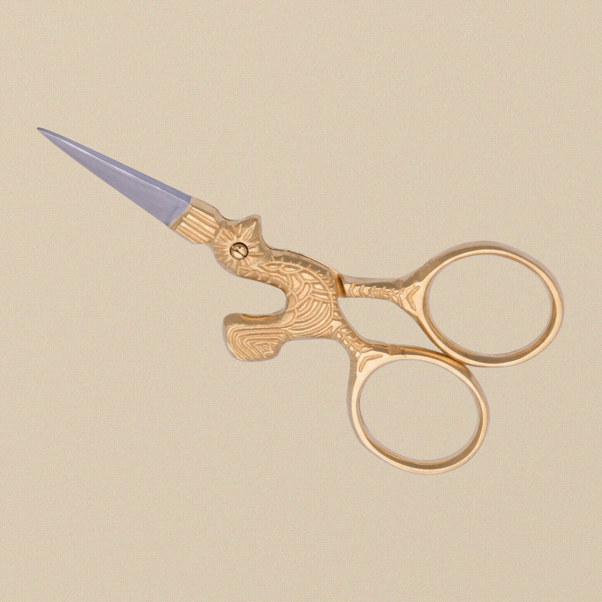 Detail shot of the gold-plated hen-shaped handles on the 3.5-inch embroidery scissors.