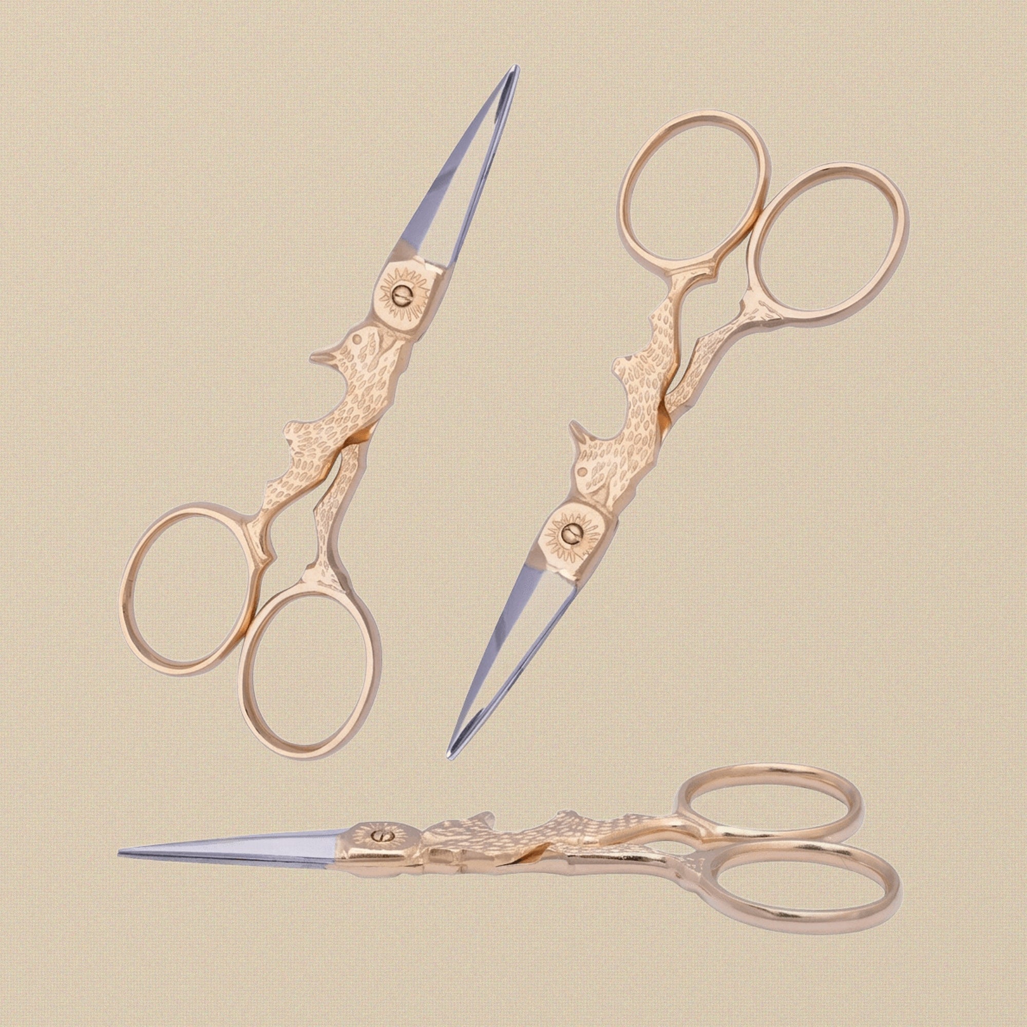 Gold-plated rabbit-shaped embroidery scissors on a white background.