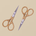 Gold-plated 4-inch embroidery scissors with engraved handles, shown closed on a white background.