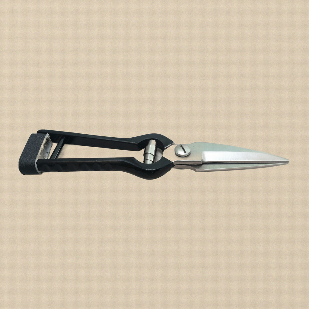 The hoof trimming shears held open to show the full length of the blades and handles.