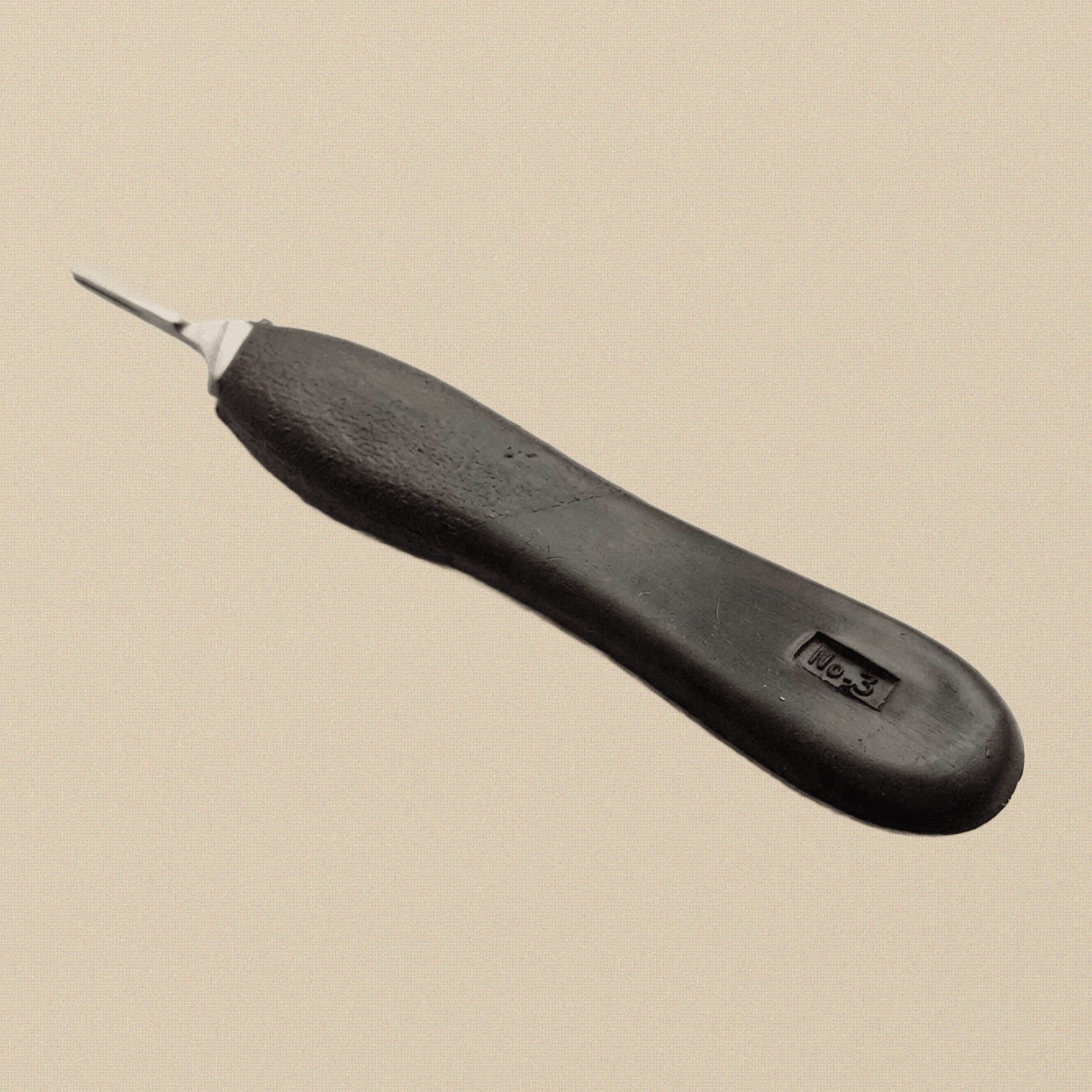 Close-up of the stainless steel No. 3 blade fitting on the scalpel handle.