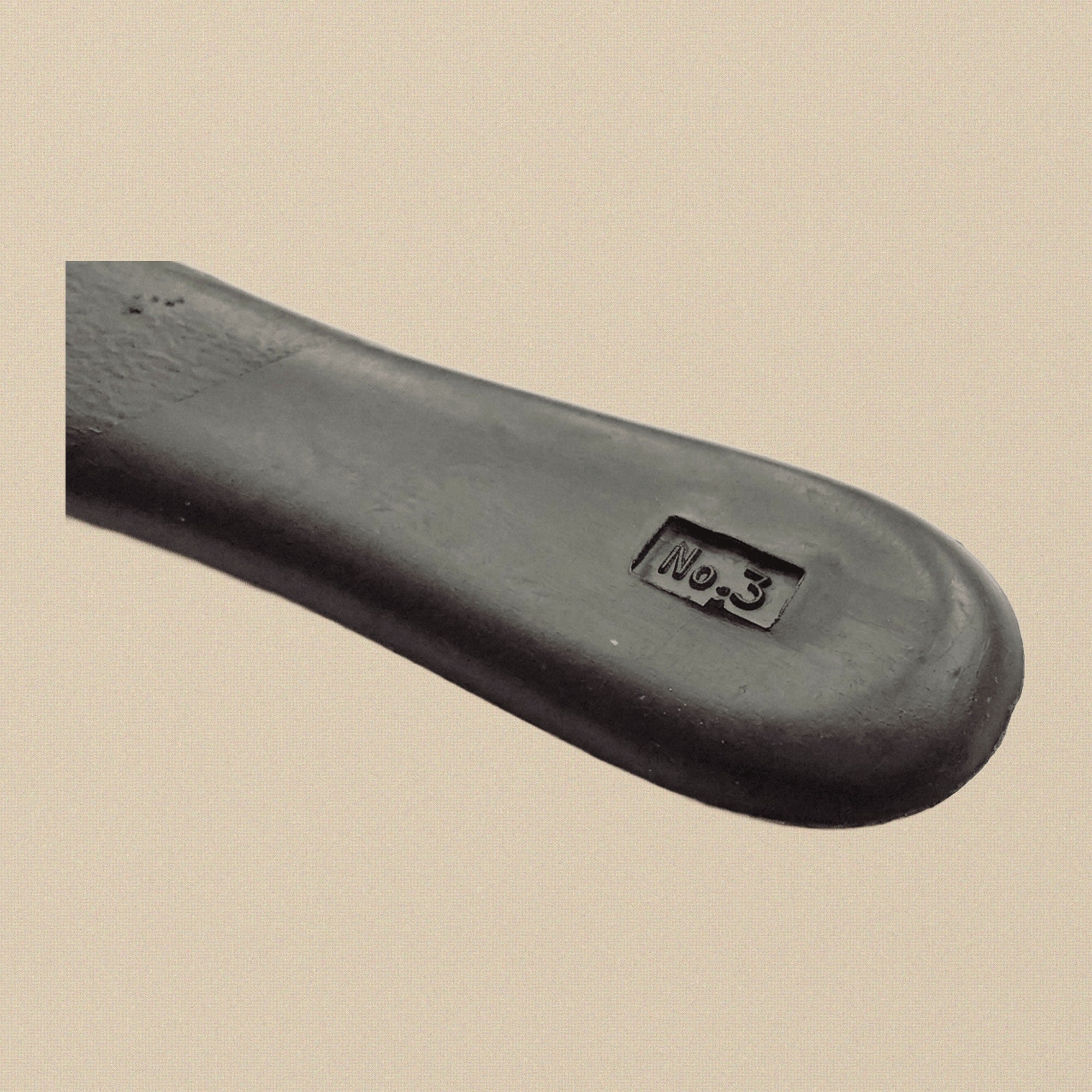 Profile view of the plastic-handled No. 3 scalpel, showing the grip texturing.