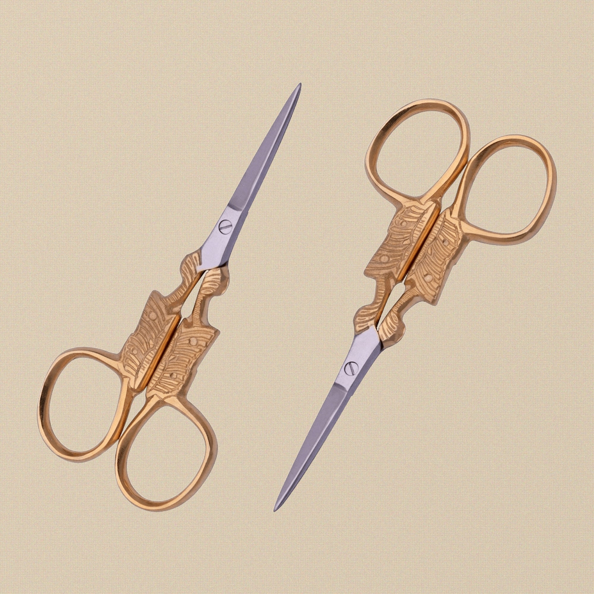 Gold-plated butterfly embroidery scissors with fine points, shown closed on a white background.