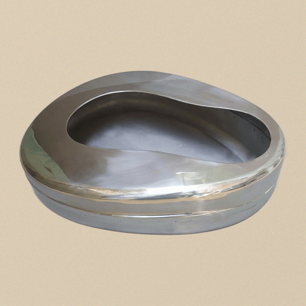 Medical-grade stainless steel adult bedpan, top-down view showing the seamless interior.