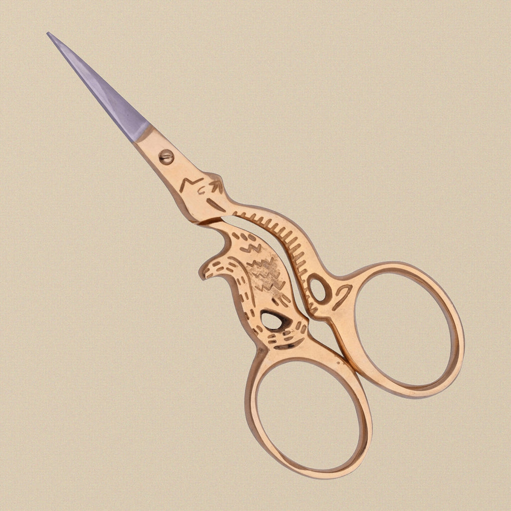 A pair of gold-plated cat-shaped embroidery scissors shown open to display the stainless steel blades.