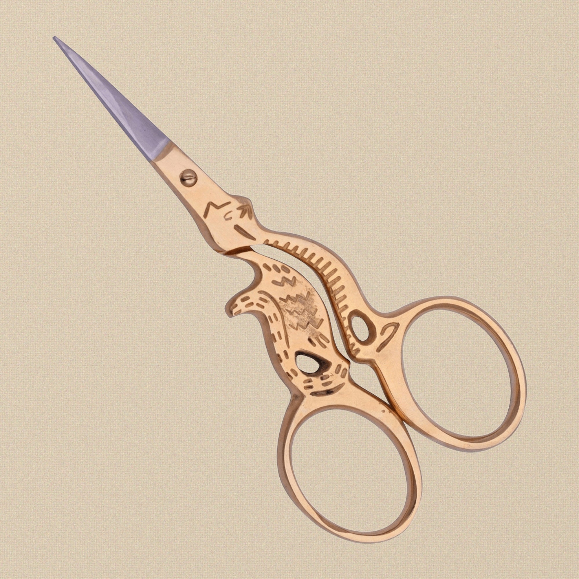 A pair of gold-plated cat-shaped embroidery scissors shown open to display the stainless steel blades.