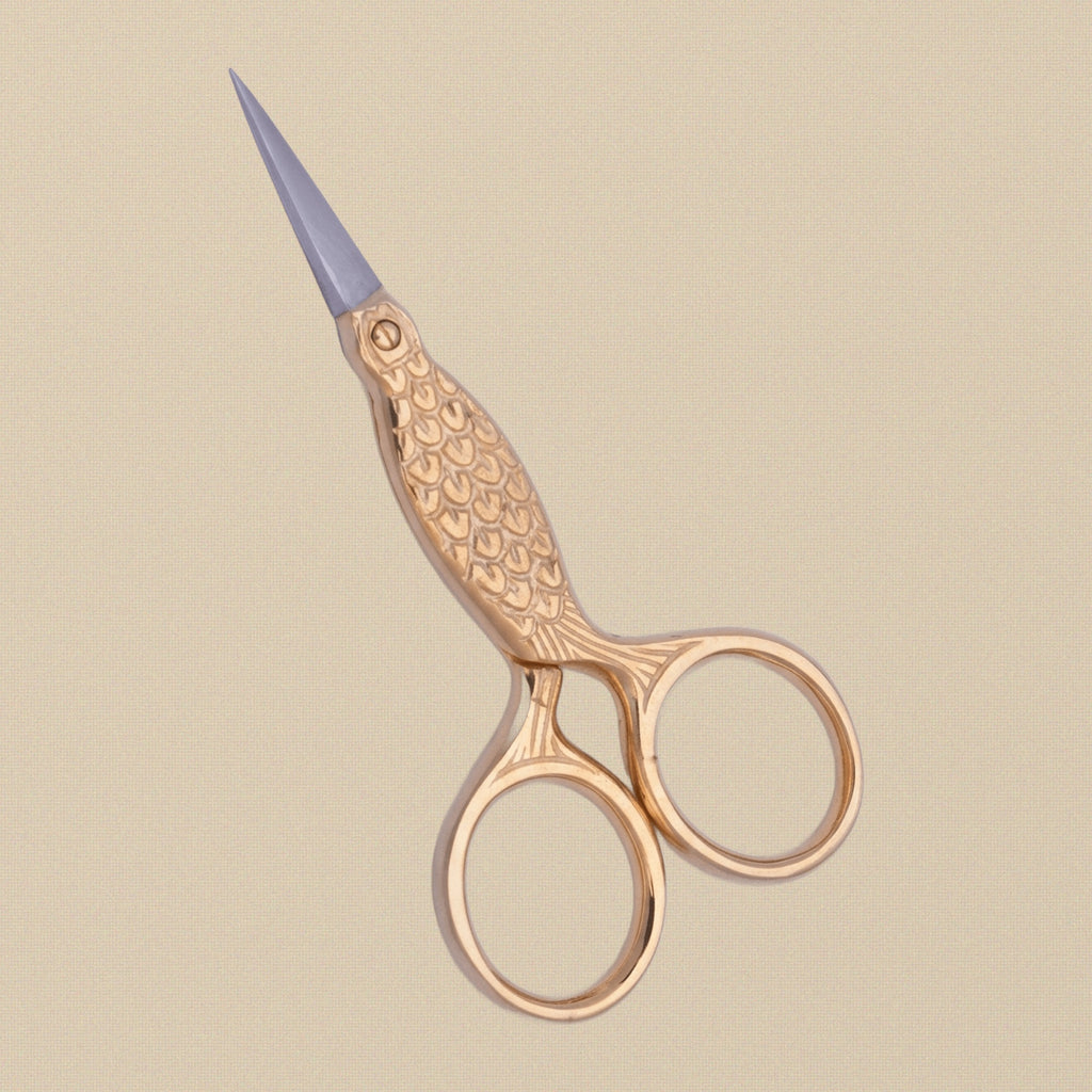 Detail shot of the fine stainless steel points on the fish-shaped embroidery scissors.