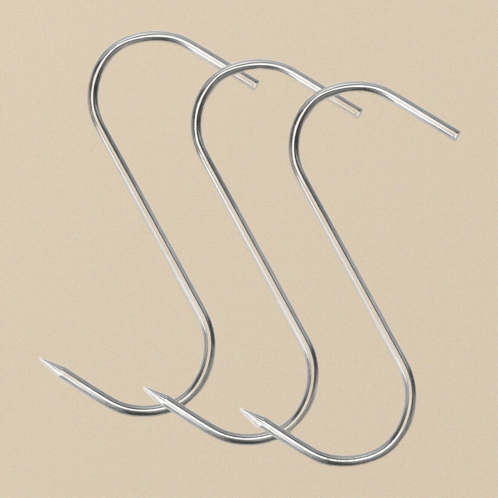 A single stainless steel S-shaped butcher's hook against a white background.