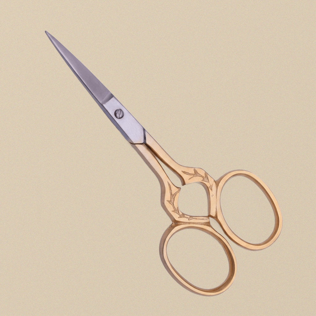 Detail shot of the fine stainless steel blades and ornate leaf handles of the 89 mm craft scissors.