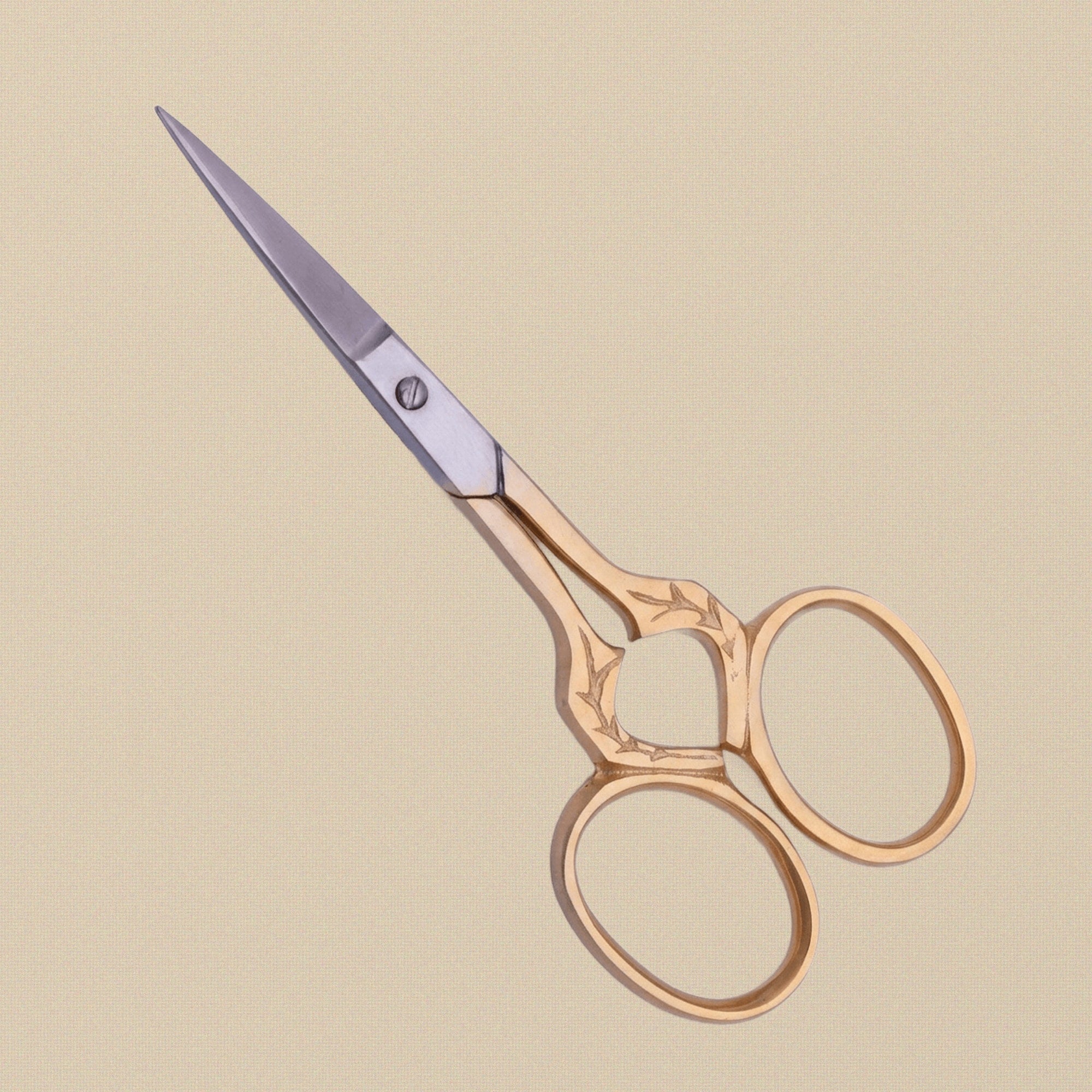 Detail shot of the fine stainless steel blades and ornate leaf handles of the 89 mm craft scissors.