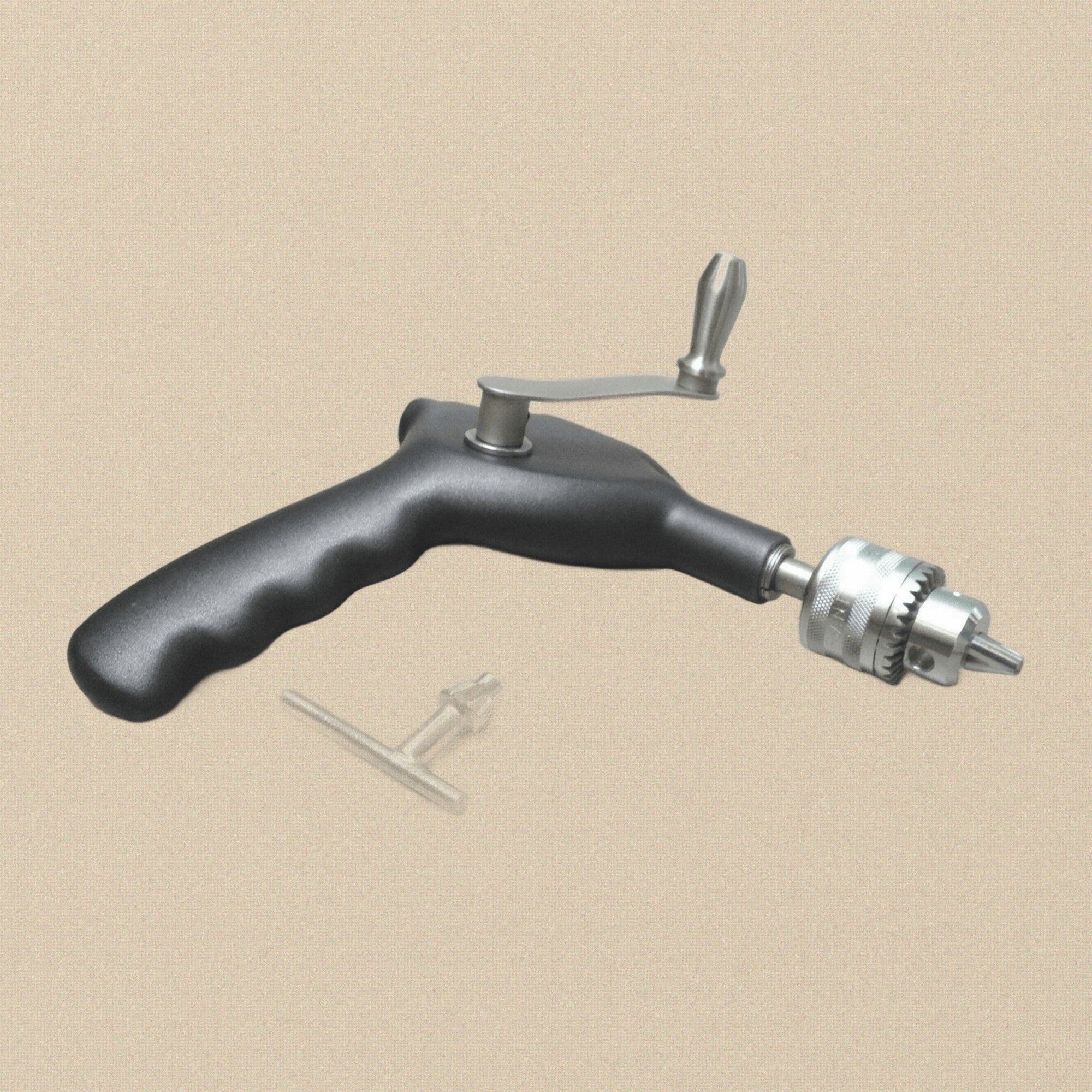 The Ralk bone hand drill held in a gloved hand to show scale and grip.