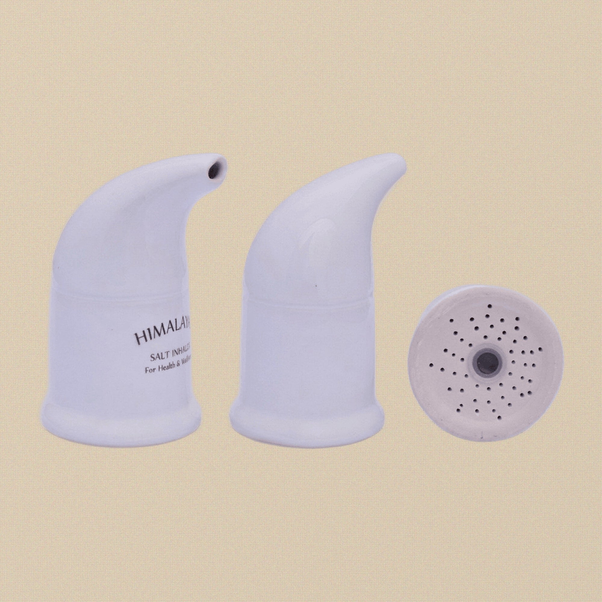 A hand holding the ceramic salt pipe inhaler to show its scale.