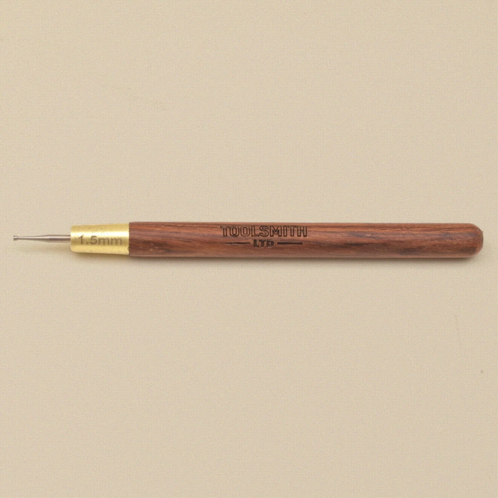 Wire rounder lying flat showing the wooden handle and brass ferrule