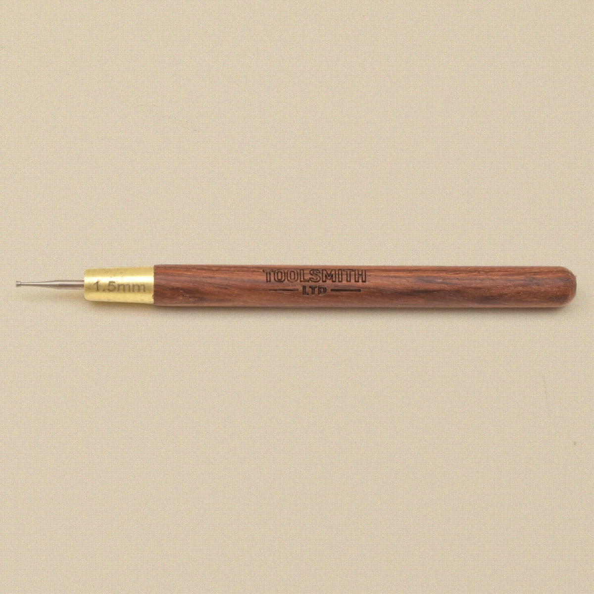 Wire rounder lying flat showing the wooden handle and brass ferrule