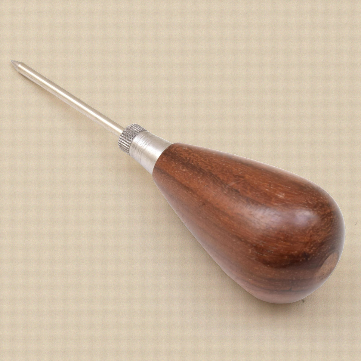 Scratch awl standing on its handle, point upward